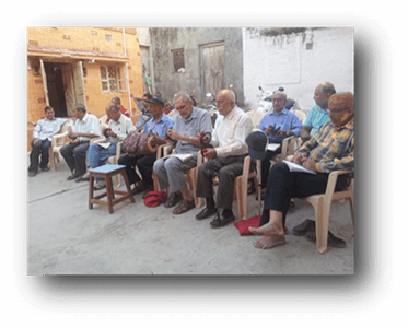 Mr. Tulsidas playing music during Holi festivities, accompanied by other distinguished members of the Gnati